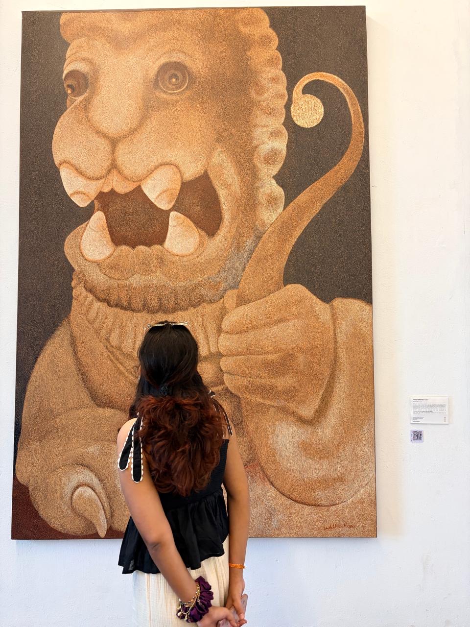 Soniya Suman looking at a large museum artwork