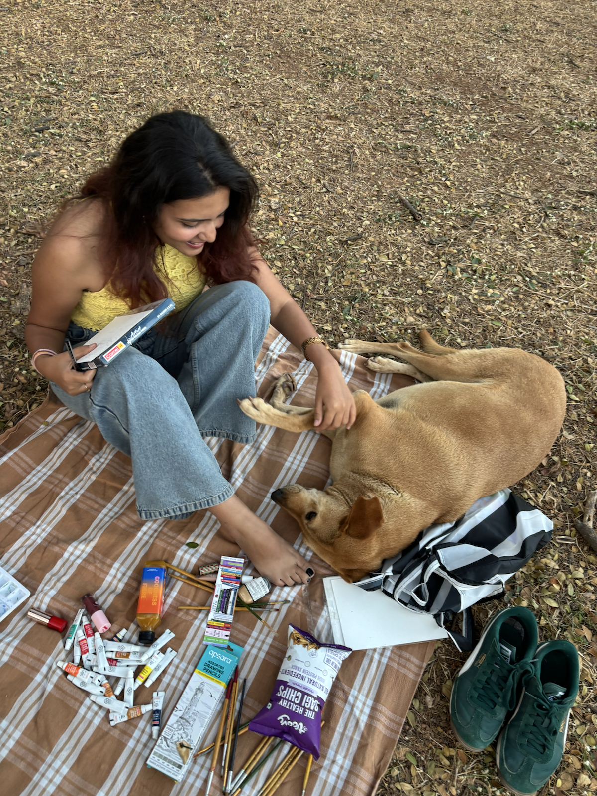 Soniya Suman sketching beside a dog