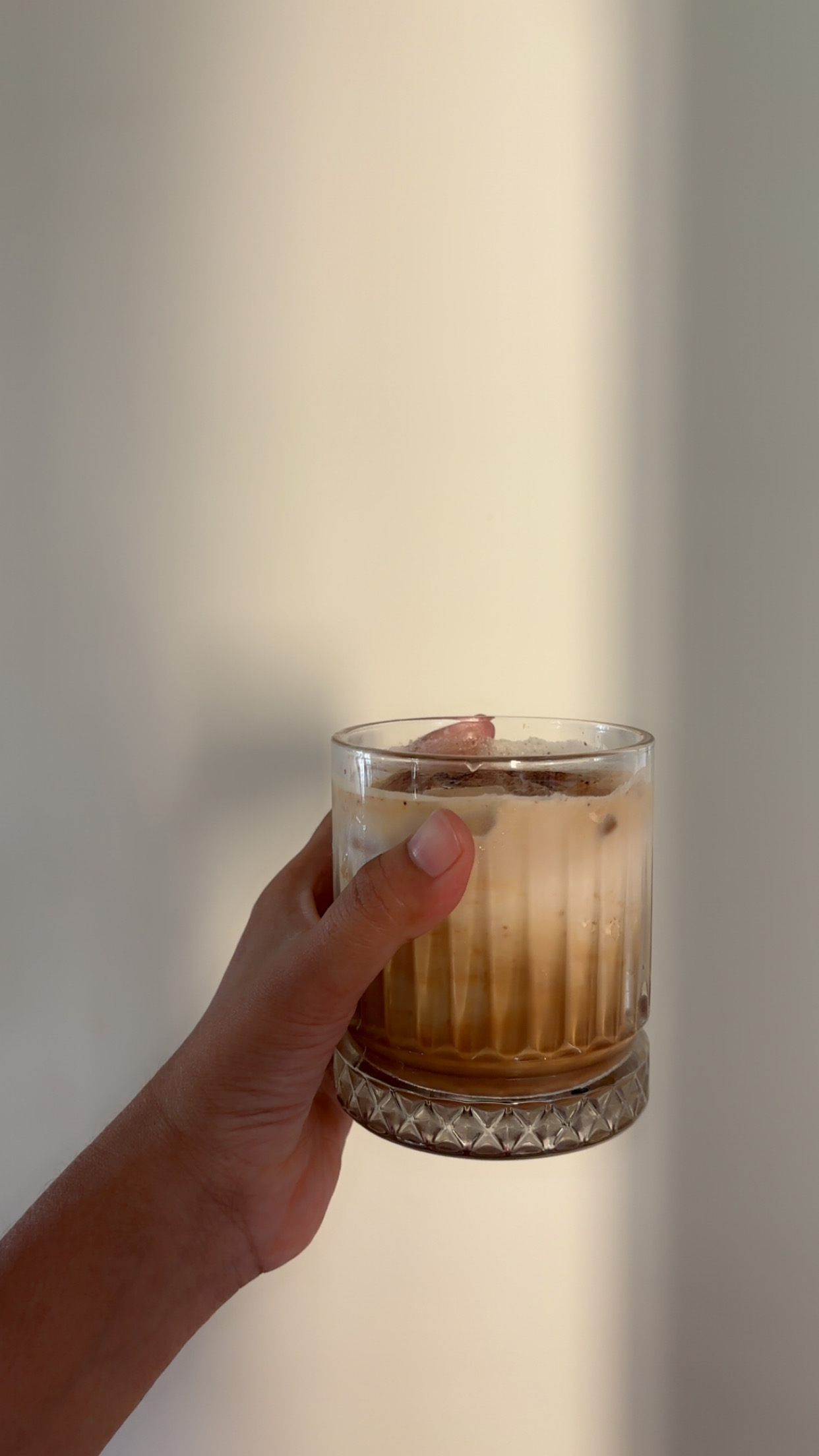 A glass of coffee in hand