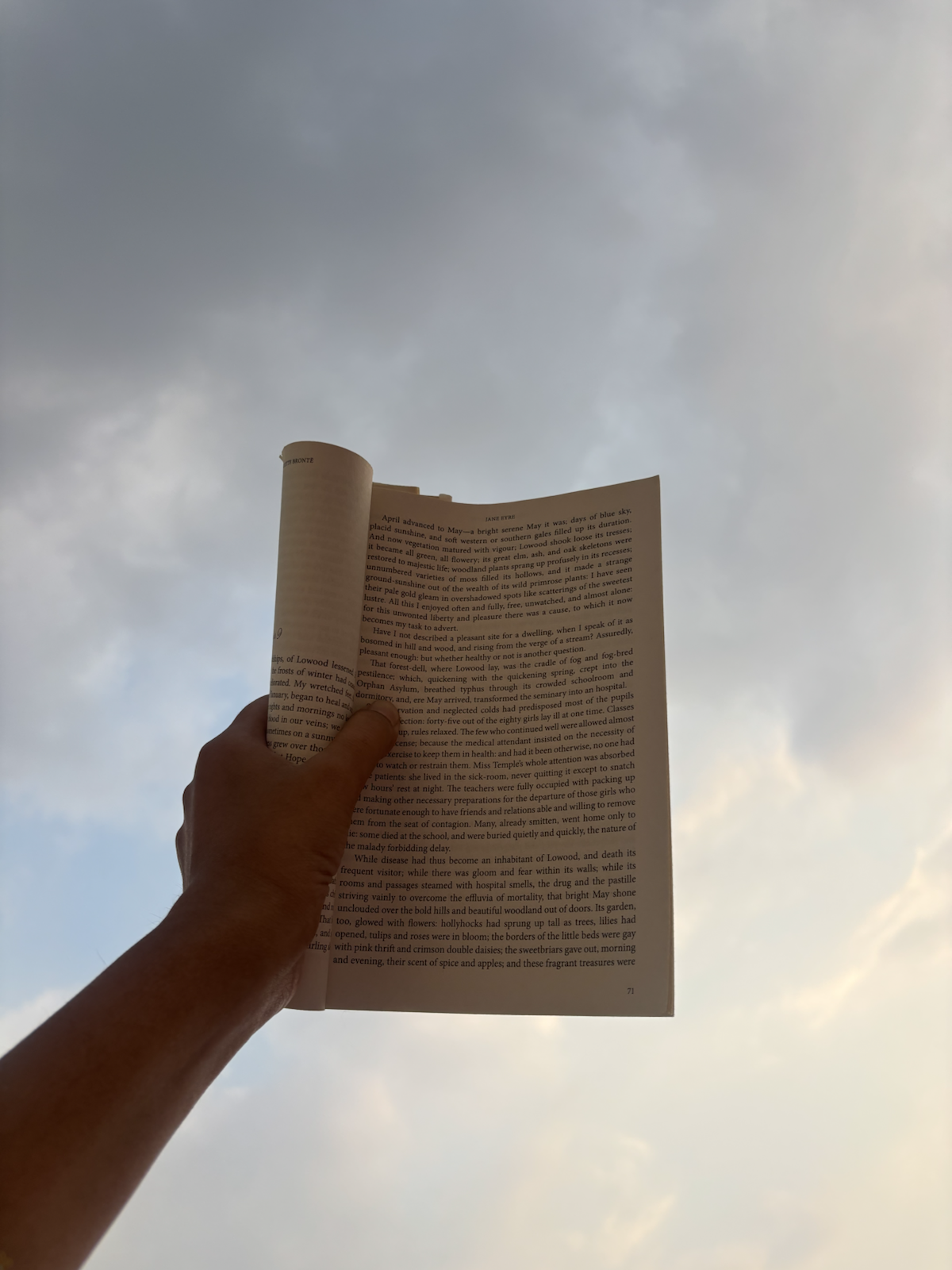 A book held against the sky