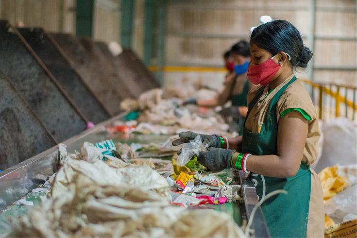 Worker sorting waste for Municipal Waste Responsibility